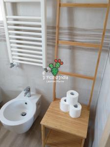 a bathroom with a white sink and a toilet at Il Fico d'India in Leporano Marina