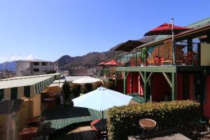 a white umbrella sitting on a balcony of a building at La Posada in Fujikawaguchiko