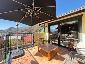 a patio with a table and an umbrella at La Posada in Fujikawaguchiko