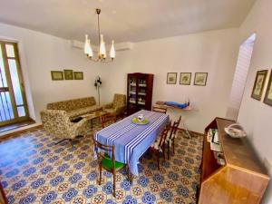 a living room with a table and a couch at CASA CELSA in Mongiove