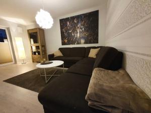a living room with a couch and a table at Ferien am Idasee 85041 in Ostrhauderfehn