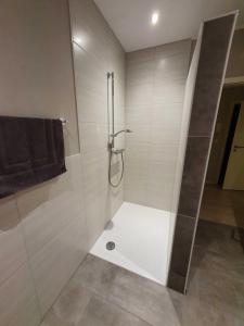 a shower with a glass door in a bathroom at Ferien am Idasee 85041 in Ostrhauderfehn +9 photos
