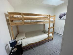 a bedroom with two bunk beds in a room at Bridge Street En Suite Rooms in Merthyr Tydfil