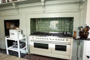a kitchen with a white stove and green tiles at Finest Retreats - Tresillian House in Newquay
