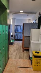 a room with green lockers and a room with blue at Albergue Rincón del Peregrino Porriño-Pleno centro-City Center in Porriño