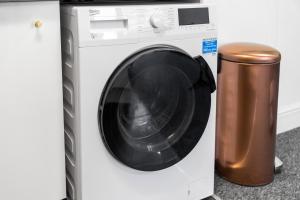 a white washing machine next to a trash can at BROADWAY SUITE - Newly refurbished stylish apartment with FREE PRIVATE PARKING - Great location in Birmingham