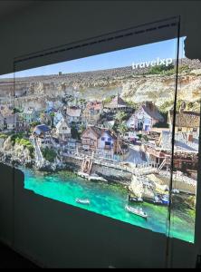 a television screen with a view of a harbor at Trafalgar Place in Auckland