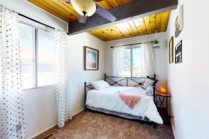 a bedroom with a bed and a window at Big Bear Bungalow in Big Bear City