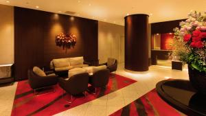 a lobby with a couch and chairs and flowers at ANA Crowne Plaza Niigata, an IHG Hotel in Niigata
