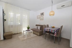 a living room with a table and a couch at M&N Apartment in Rovinj