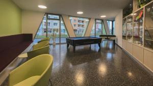 a room with a pool table and some chairs at Jugendherberge Braunschweig in Braunschweig