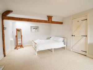 a bedroom with a bed and a sliding barn door at The Lymings in Lyme Regis