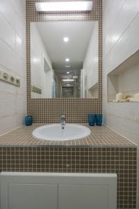 a bathroom with a sink and a mirror at The Spot Apartment in Prague