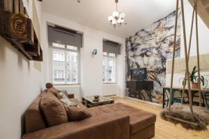 a living room with a couch and a painting on the wall at The Spot Apartment in Prague