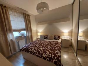 ein Schlafzimmer mit einem großen Bett und einem Fenster in der Unterkunft SAS Apartamenty Perfect in Stettin