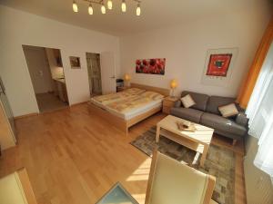 a living room with a bed and a couch at City Center Apartments Vienna in Vienna