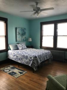a bedroom with a bed and a ceiling fan at Old Time Beach Front Cottage - The Beach is your Backyard! Pet Friendly cottage in North Camellia Acres