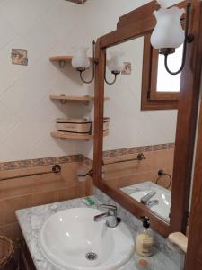 a bathroom with a sink and a mirror at Casa Los Trillizos in Pampaneira