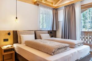 Postel nebo postele na pokoji v ubytování Les Ciases Chalets Dolomites Apt 3
