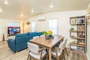 a living room with a blue couch and a wooden table at NEW Charming Country Style 3B2B in Glendora