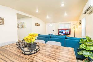 a living room with a blue couch and a table at NEW Charming Country Style 3B2B in Glendora