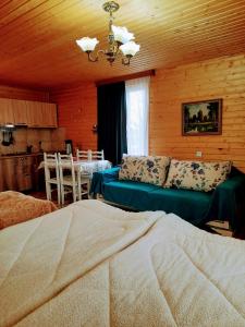 a bedroom with a bed and a dining room at Family Hotel Maia - Cемейная гостиница Майя in Dashbashi