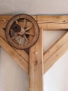 a wooden wagon wheel hanging on a ceiling at Kmetija Muže in Bled