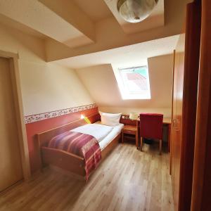 a small bedroom with a bed and a table at Nordischer Hof in Krakow am See +48 photos