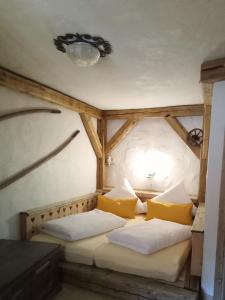 a bedroom with two beds in a room with a chandelier at Kmetija Muže in Bled