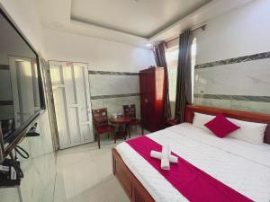 a bedroom with a large bed with a red blanket at kim'hotel near SECC - FV in Ho Chi Minh City