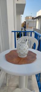 a white table with a bowl on top of it at Kato Yialos Paros in Parikia