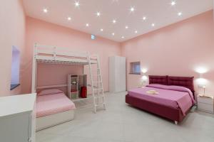 a bedroom with two bunk beds and a ladder at La Stella dei venti in Vico Equense