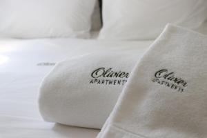 a white pillow with the words anaheim participant on it at Olivier Premium Apartments - Downtown Lisbon in Lisbon +4 photos