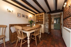 a kitchen with a wooden table and chairs at Dale End Cottage, Brassington in Brassington