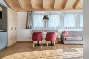 a living room with a table and a couch at Les Ciases Chalets Dolomites Apt 6 in San Vigilio Di Marebbe