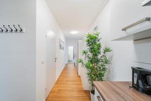 a hallway of a house with white walls and wooden floors at Central Apartment Lofts in Vienna