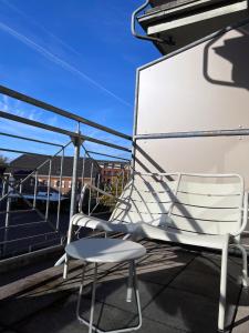 einen weißen Stuhl auf dem Balkon in der Unterkunft AvidonApartments in Düsseldorf