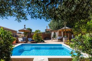 a swimming pool in the backyard of a house at Casa Martin in Calvià