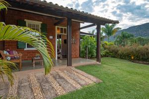 una casa de ladrillo con porche y patio en Brisa da Serra Pousada Boutique, en Tiradentes