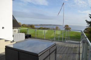 a balcony with a view of the water at Naturperlen in Rødekro