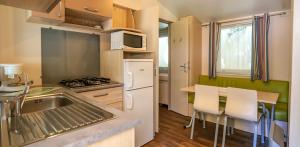a kitchen with a sink and a counter top at Amelia Camping in Amélie-les-Bains-Palalda