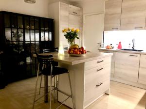 a kitchen with a counter with a bowl of fruit on it at Luxurious Boutique Apartment, inner city, next to Canals and Metro station in Copenhagen