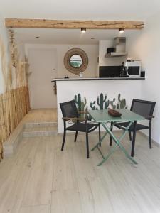 a dining room with a table and two chairs at Casa Louise Suites and Spas privatifs in Sainte-Maxime