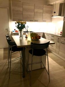 a kitchen with a table with a bowl of fruit on it at Luxurious Boutique Apartment, inner city, next to Canals and Metro station in Copenhagen