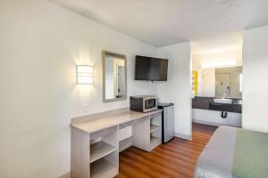 a hotel room with a desk with a microwave at Motel 6 Clarkston WA in Clarkston