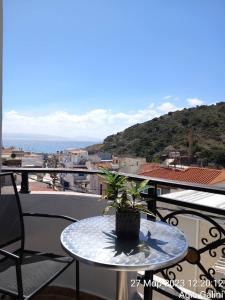 una mesa con una planta en la parte superior de un balcón en Happy Days, en Agia Galini