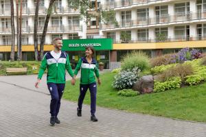 a man and a woman walking down a sidewalk at Medical SPA "Eglės sanatorija" Birštonas in Birštonas