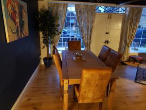 a dining room with a wooden table and chairs at Bay House in Broadway