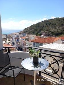 a table and chairs on a balcony with a view at Happy Days in Agia Galini