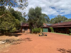 a house with a dirt yard in front of it at Bentworth Lodge in Carramar